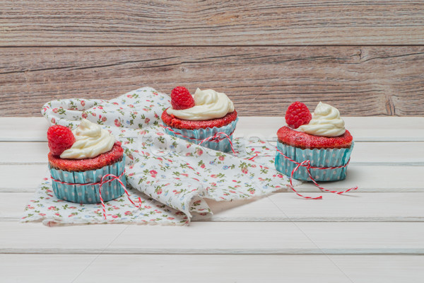 Red cupcakes with cream cheese frosting Stock photo © homydesign