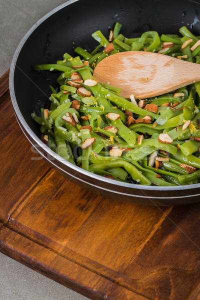 Green beans with roasted almonds Stock photo © homydesign