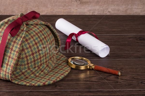 Wrapped paper sheets and magnifying glass Stock photo © homydesign