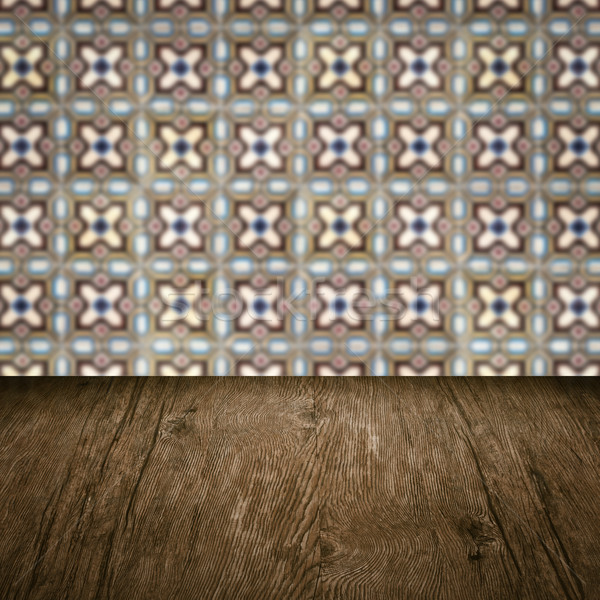 Stock photo: Wood table top and blur vintage ceramic tile pattern wall