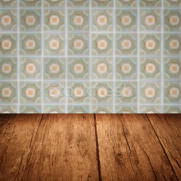 Stock photo: Wood table top and blur vintage ceramic tile pattern wall