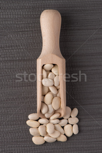 Wooden scoop with white beans Stock photo © homydesign
