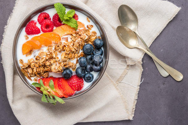 Yogurt with baked granola and berries Stock photo © homydesign
