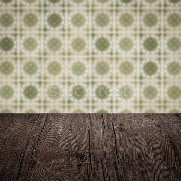 Wood table top and blur vintage ceramic tile pattern wall Stock photo © homydesign