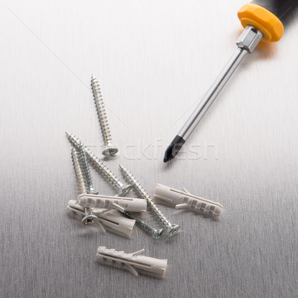 Screwdriver, screws and plastic dowels Stock photo © homydesign