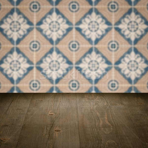 Wood table top and blur vintage ceramic tile pattern wall Stock photo © homydesign