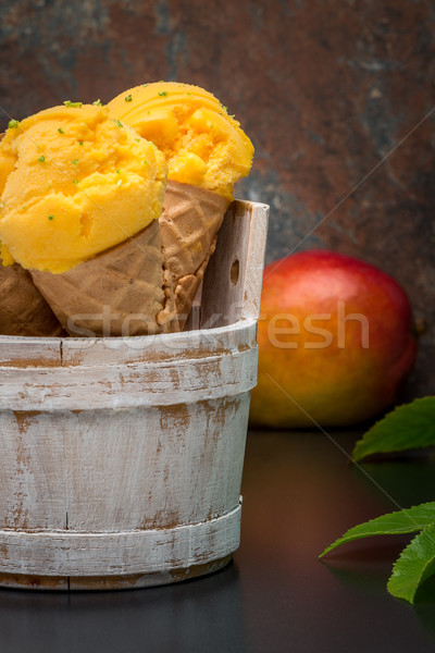 Homemade mango ice cream in waffle cone Stock photo © homydesign