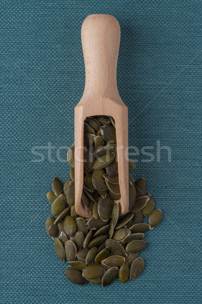 Wooden scoop with pumpkin seeds Stock photo © homydesign