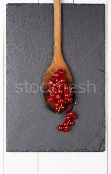 Currants in a wooden spoon Stock photo © homydesign