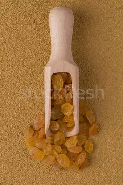 Wooden scoop with golden raisins Stock photo © homydesign