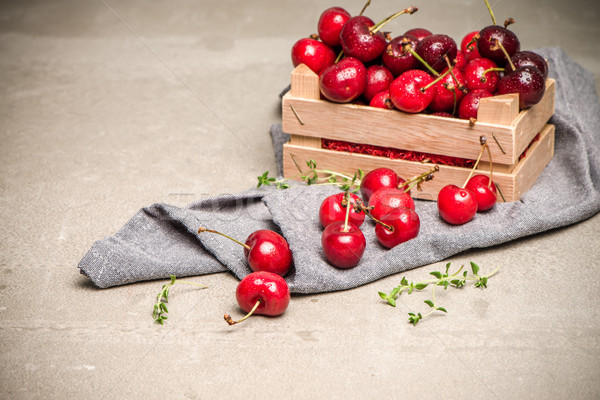 Red ripe cherries in small wooden box Stock photo © homydesign