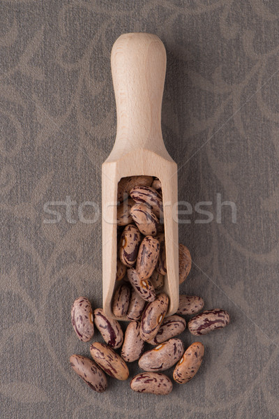 Wooden scoop with pinto beans Stock photo © homydesign