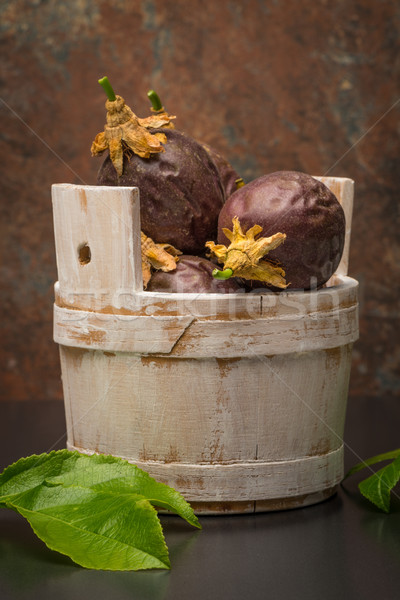 Stock photo: Passion fruits s on a wooden bucket