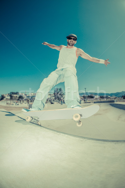 Skateboarder in a concrete pool  Stock photo © homydesign