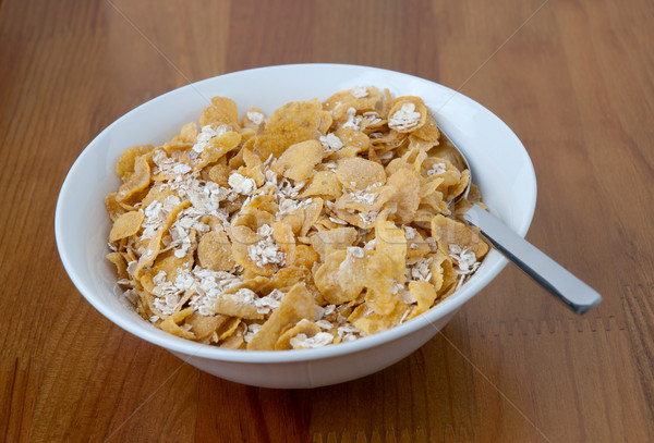 White bowl with a spoon, corn and oats flakes Stock photo © homydesign