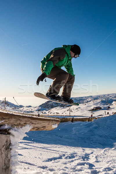 Snowboarder jumping against blue sky Stock photo © homydesign