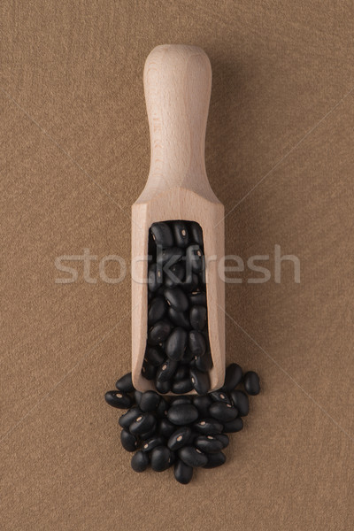 Wooden scoop with black beans Stock photo © homydesign