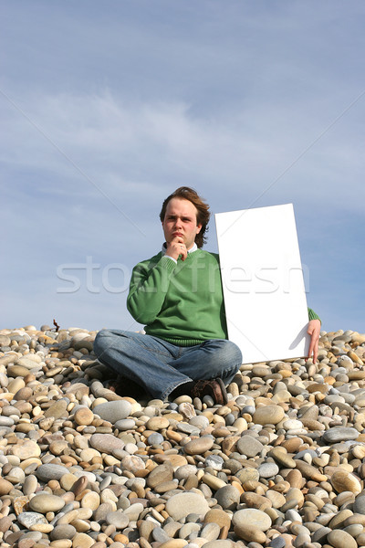 Young Man Holding White Card at the beach Stock photo © hsfelix