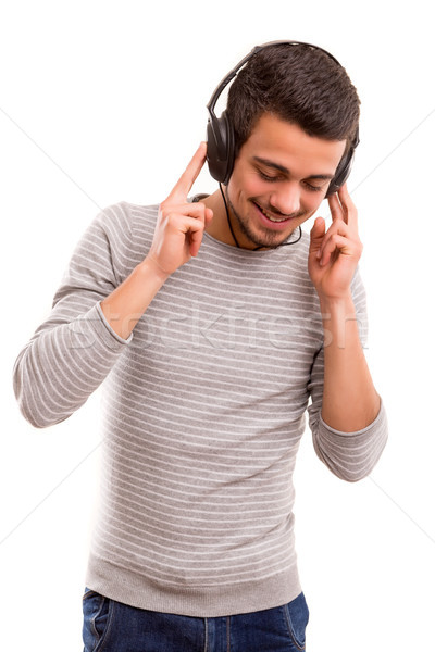 Hombre escuchar música feliz joven auriculares cara Foto stock © hsfelix