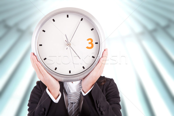 Business woman holding a clock Stock photo © hsfelix