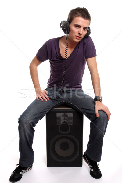 Young man with headphones, seating in a speaker Stock photo © hsfelix