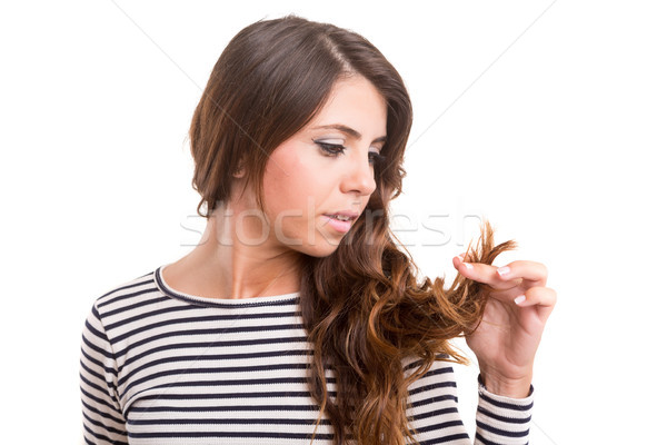 Young woman looking at her hair Stock photo © hsfelix