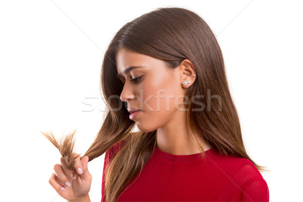 Young woman looking at her hair Stock photo © hsfelix