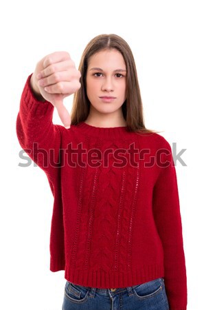 Nem siralmas stúdiófelvétel fiatal nő hüvelykujjak lefelé Stock fotó © hsfelix