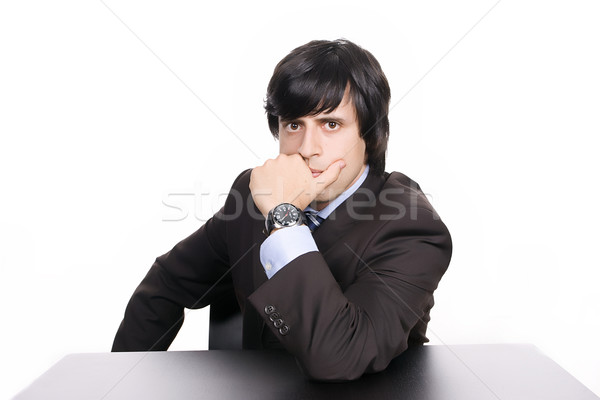Young Businessman over a desk, full of thoughts Stock photo © hsfelix
