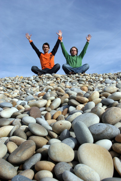two young men with raised arms at the beach - focus on 1st plan Stock photo © hsfelix