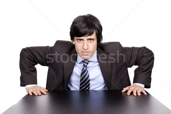 Young Businessman over a desk, full of thoughts Stock photo © hsfelix