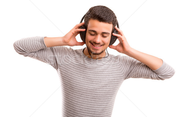 Hombre escuchar música feliz joven auriculares cara Foto stock © hsfelix