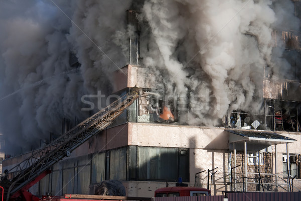 Tűzoltó tűz égő füst vészhelyzet szolgáltatás Stock fotó © ia_64