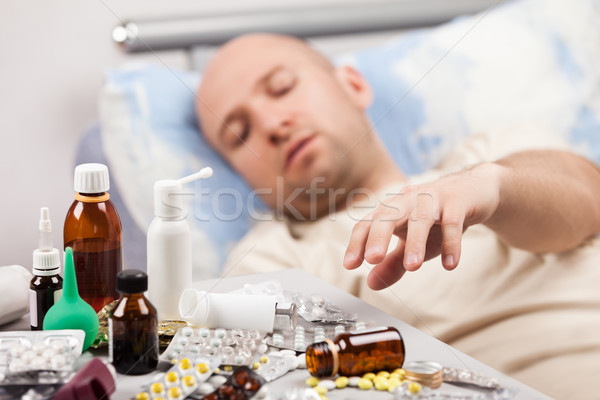 Indiszponált férfi beteg fekszik ágy felnőtt Stock fotó © ia_64