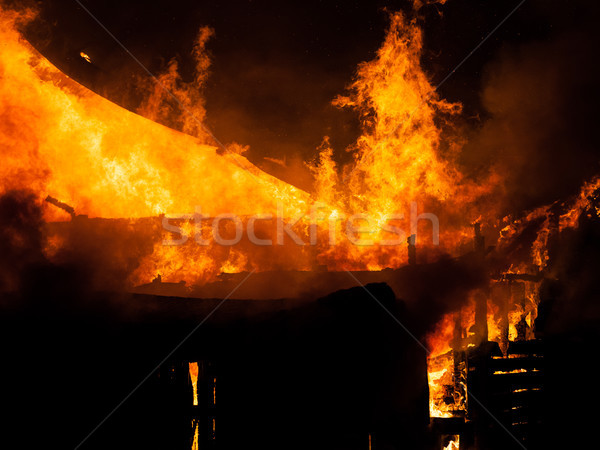 Burning fire flame on wooden house roof Stock photo © ia_64