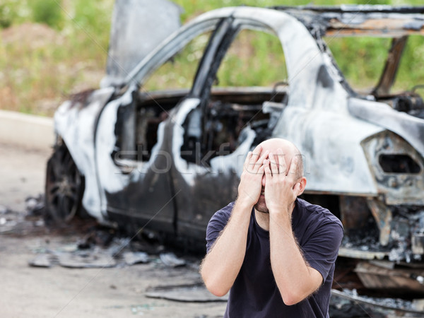 Crying upset man at arson fire burnt car vehicle junk Stock photo © ia_64