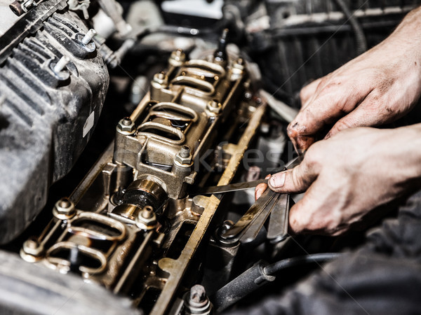 Automobile service worker or garage mechanic repairing auto car engine Stock photo © ia_64