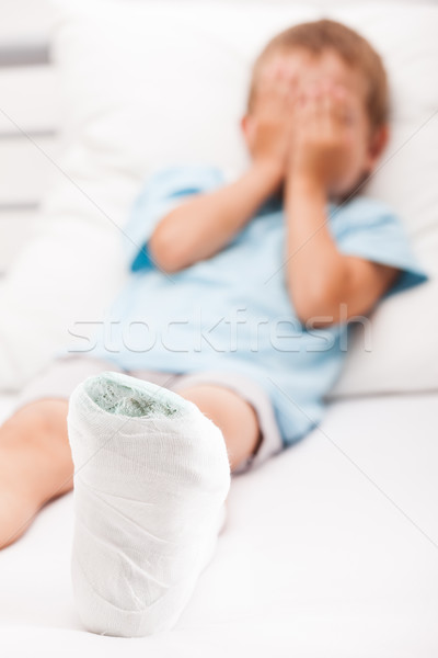 Little child boy with plaster bandage on leg heel fracture or br Stock photo © ia_64