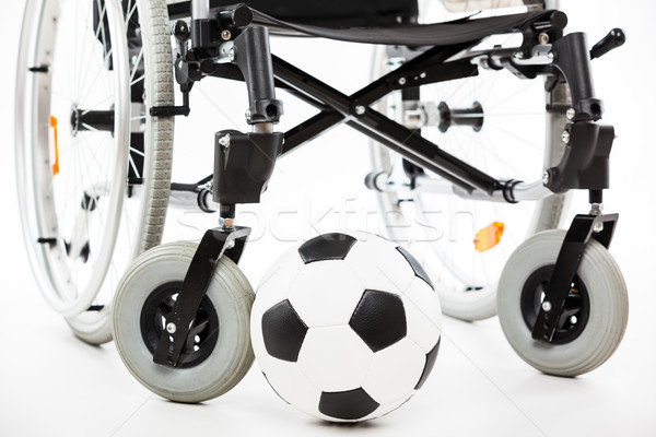 Wheelchair for invalid or disabled person and soccer ball Stock photo © ia_64
