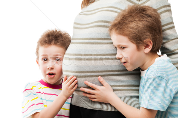Two little sons touching or bonding their pregnant mother abdome Stock photo © ia_64