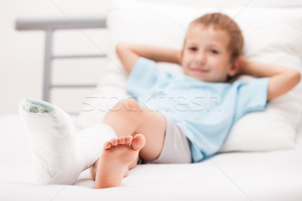 Little child boy with plaster bandage on leg heel fracture or br Stock photo © ia_64