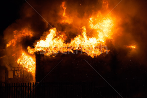 Burning fire flame on wooden house roof Stock photo © ia_64