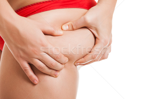 Overweight woman holding or pinching fat body bottom or buttocks Stock photo © ia_64