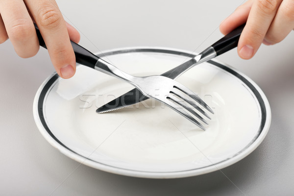 Stock photo: Hand holding fork and knife