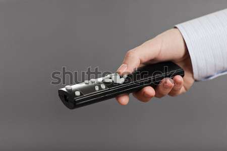 Human hand holding tv channel remote control Stock photo © ia_64