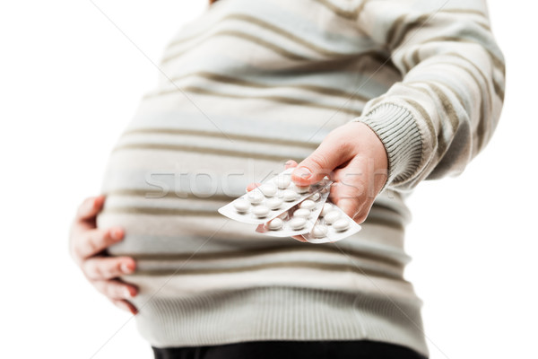 Pregnant woman holding vitamin pills Stock photo © ia_64