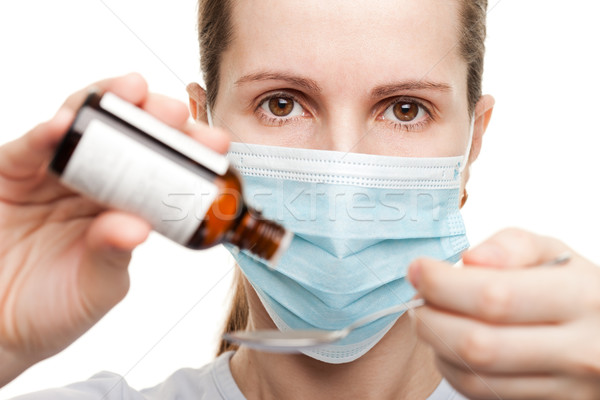 Doctor in mask holding medicine syrup Stock photo © ia_64