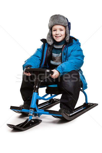 Child on snow scooter or snowmobile toy Stock photo © ia_64
