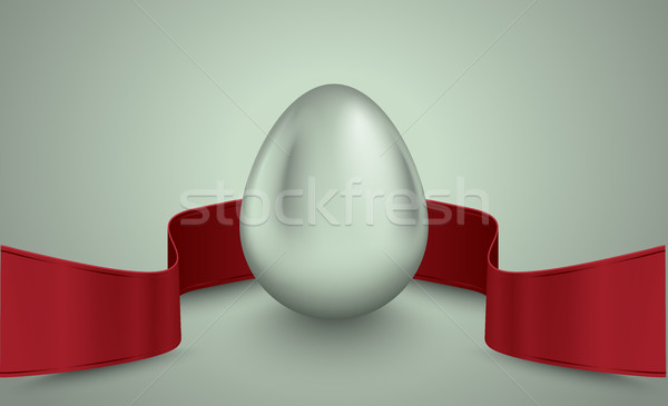 Glossy silver egg with red winding tape. Grey light retro ribbon background Easter idea Stock photo © Iaroslava