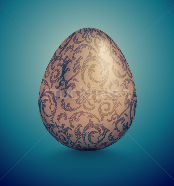 Glossy realistic golden egg with blue ink handdrawn floral pattern. Isolated on turquoise background Stock photo © Iaroslava